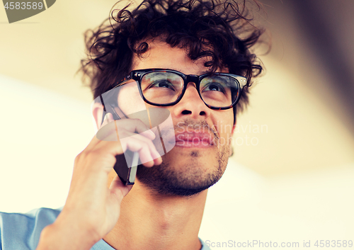 Image of man with smartphone calling on city street