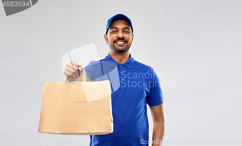 Image of happy indian delivery man with food in paper bag