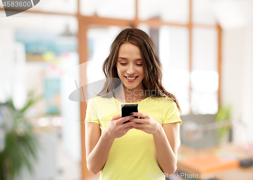 Image of young woman or teenage girl using smartphone