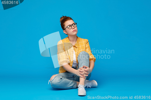 Image of redhead teenage student girl in glasses dreaming