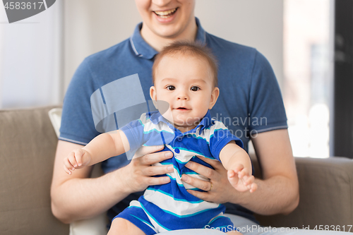 Image of happy baby son with father at home