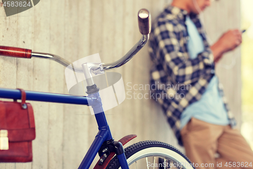 Image of man with fixed gear bicycle on street