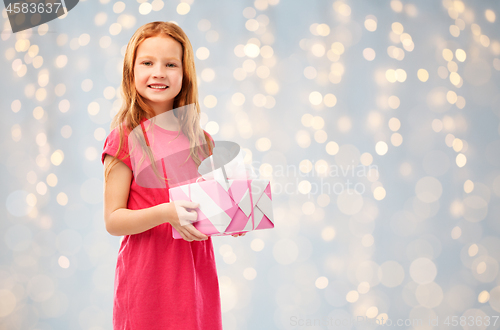 Image of smiling red haired girl with birthday gift