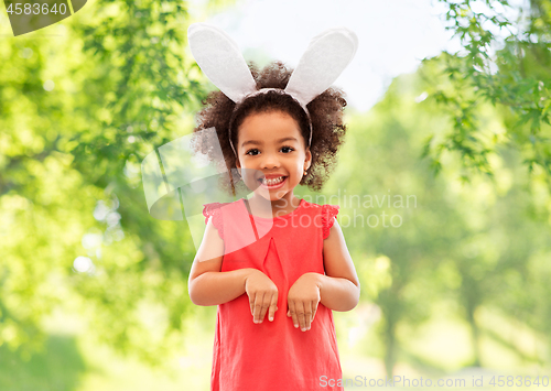 Image of happy little girl wearing easter bunny ears