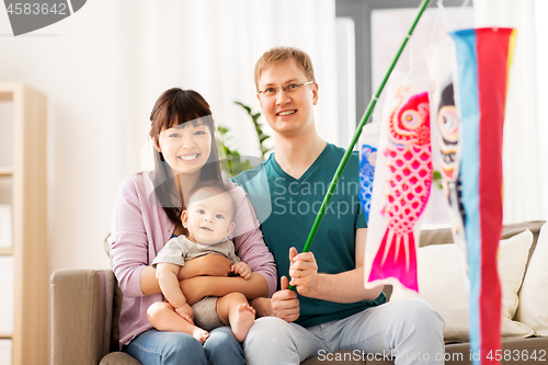 Image of mixed-race family with koinobori carp streamer