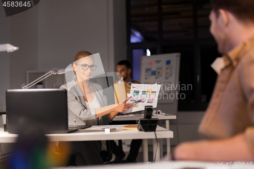 Image of designers or software developers at night office