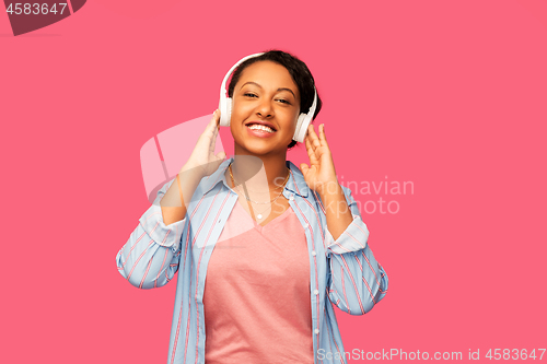 Image of african woman in headphones listening to music