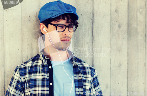 Image of man with earphones listening to music on street
