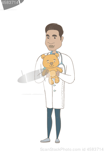 Image of Young hispanic pediatrician holding teddy bear.