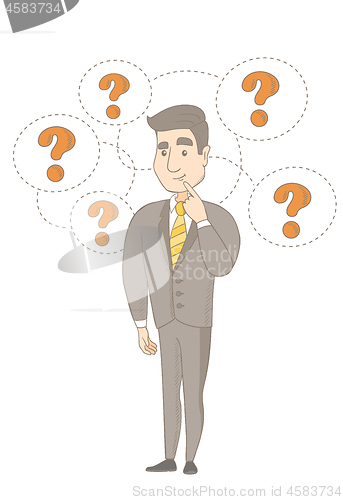 Image of Young caucasian businessman under question marks.