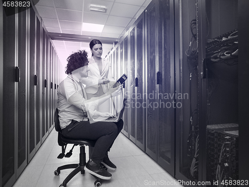 Image of technicians working together on servers