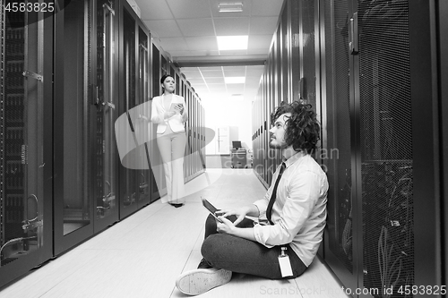 Image of young technicians working together on servers