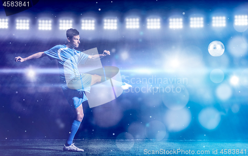 Image of soccer player in front of big modern stadium with flares and lig