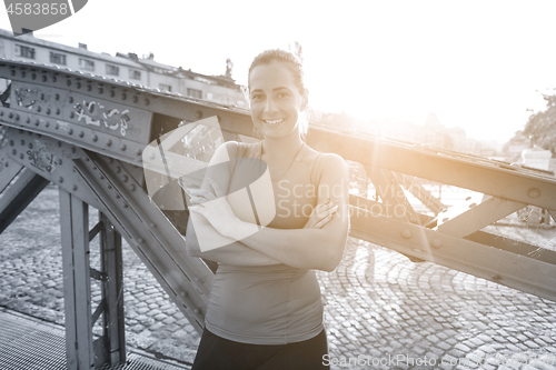 Image of portrait of a jogging woman at sunny morning