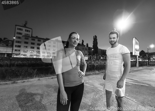 Image of couple warming up and stretching