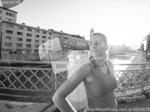 Image of portrait of a jogging woman at sunny morning