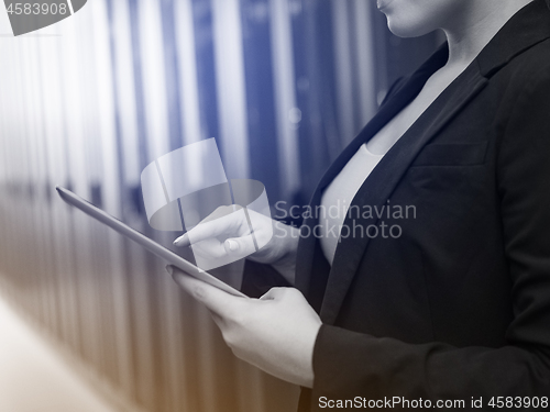 Image of Female engineer working on a tablet computer in server room