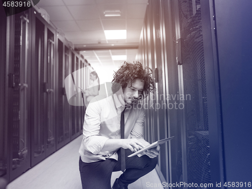 Image of young technicians working together on servers