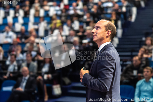 Image of Public speaker giving talk at Business Event.