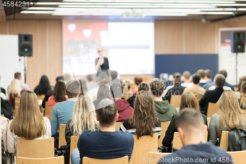 Image of Female speaker giving presentation on business conference.