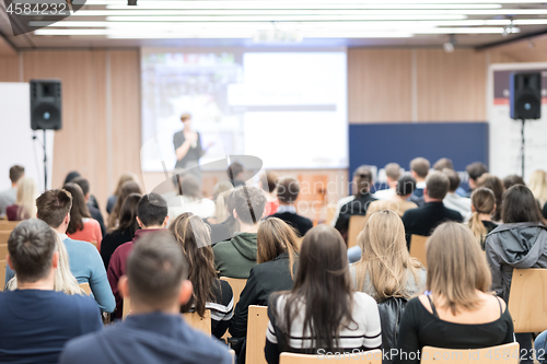 Image of Female speaker giving presentation on business conference.
