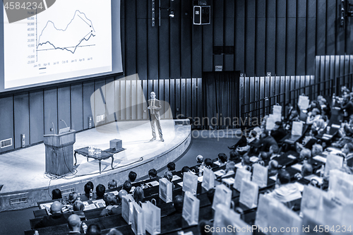 Image of Speaker giving presentation on business conference event.