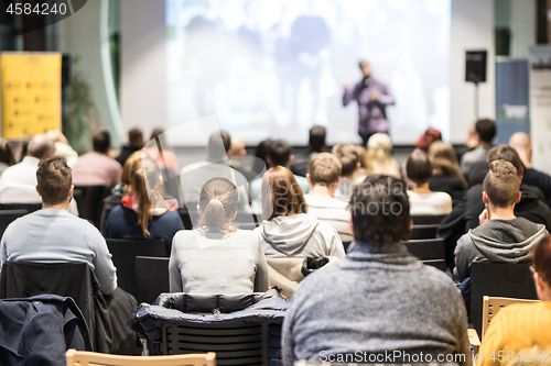 Image of Business speaker giving a talk at business conference event.