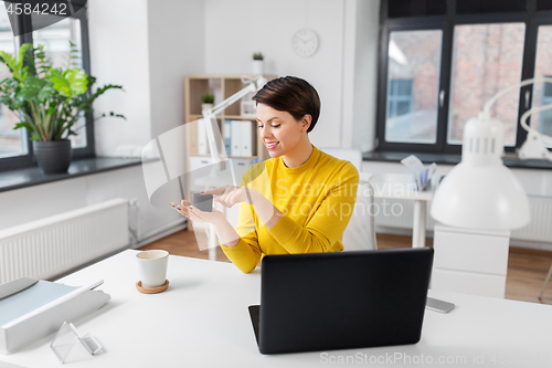 Image of businesswoman using smart speaker at office