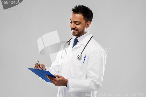 Image of indian male doctor with clipboard and stethoscope