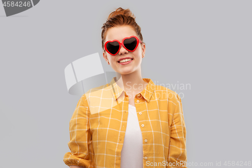 Image of red haired teenage girl in heart-shaped sunglasses