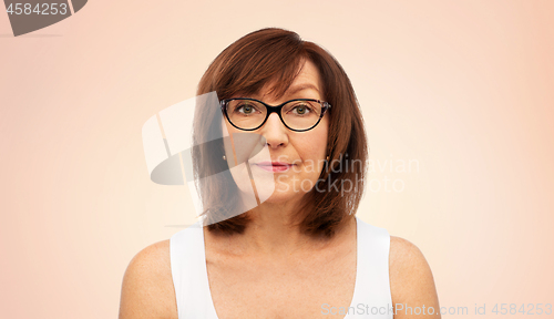 Image of portrait of senior woman in glasses over white