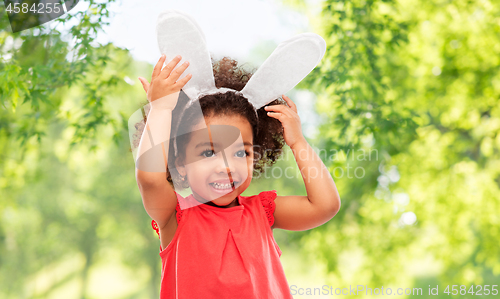 Image of happy little girl wearing easter bunny ears