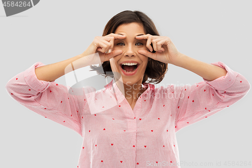 Image of happy young woman in pajama opening her eyes