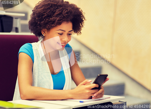 Image of african student girl with smartphone on lecture