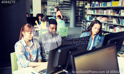 Image of international students with computers at library