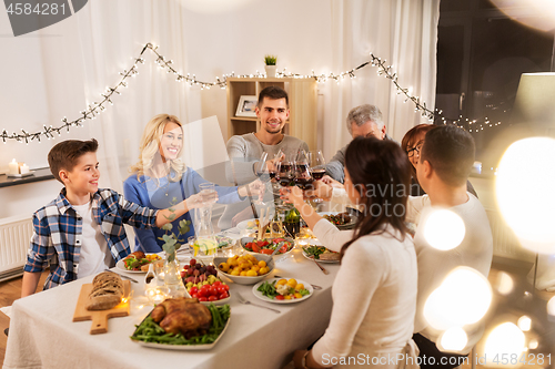 Image of happy family having dinner party at home