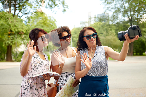 Image of women with map travelling and recording video blog