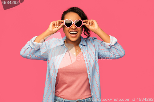 Image of african american woman in heart-shaped sunglasses