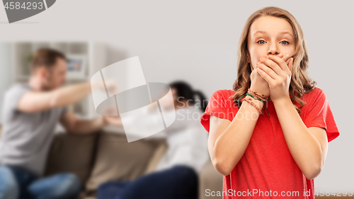 Image of girl covering mouth over her parents having fight