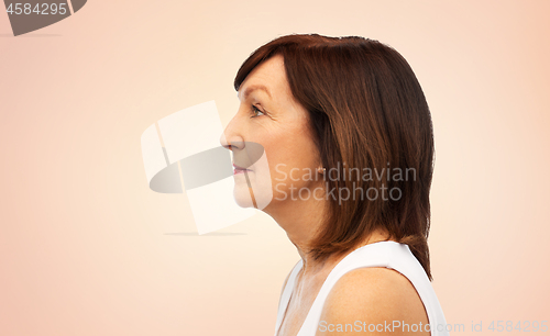 Image of profile of senior woman over white background