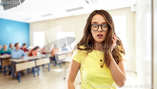 Image of scared teenage student girl in glasses at school