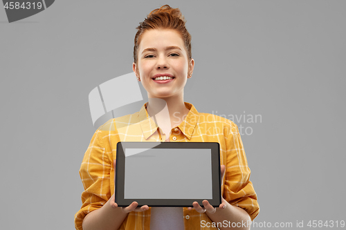 Image of red haired teenage girl showing tablet computer