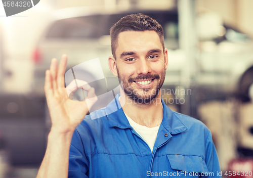 Image of auto mechanic or smith showing ok at car workshop