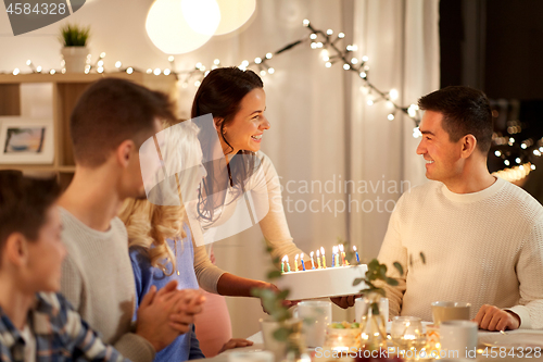 Image of happy family having birthday party at home