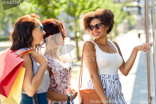 Image of women with shopping bags looking at shop window