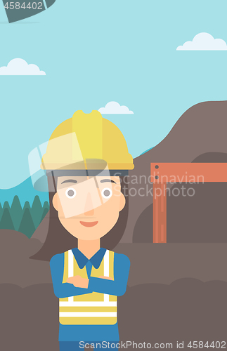 Image of Miner with mining equipment on background.