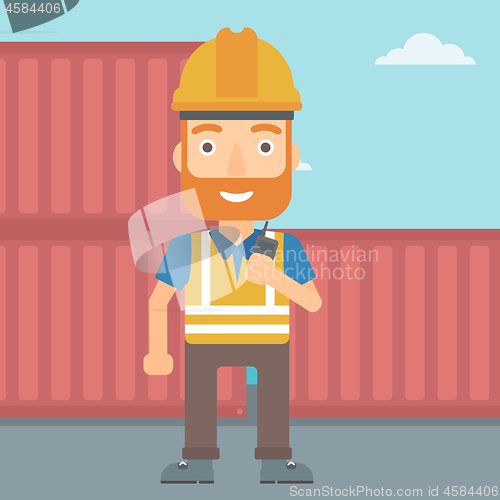 Image of Stevedore standing on cargo containers background.