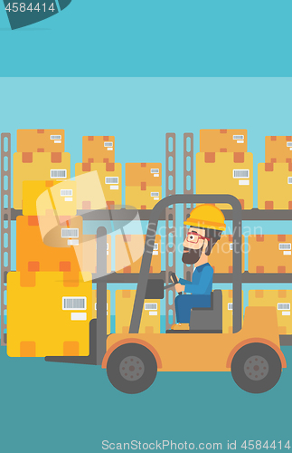 Image of Warehouse worker moving load by forklift truck.