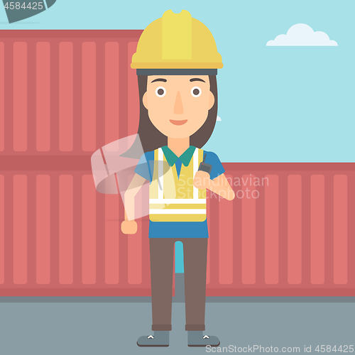 Image of Stevedore standing on cargo containers background.