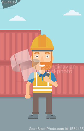 Image of Stevedore standing on cargo containers background.